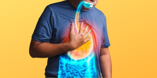 man suffering from heartburn with his hand on his chest